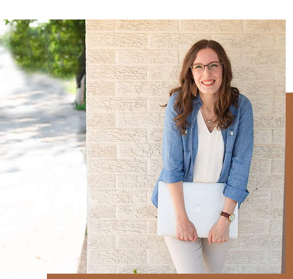 Pinterest strategist sara motes smiling against a white brick wall