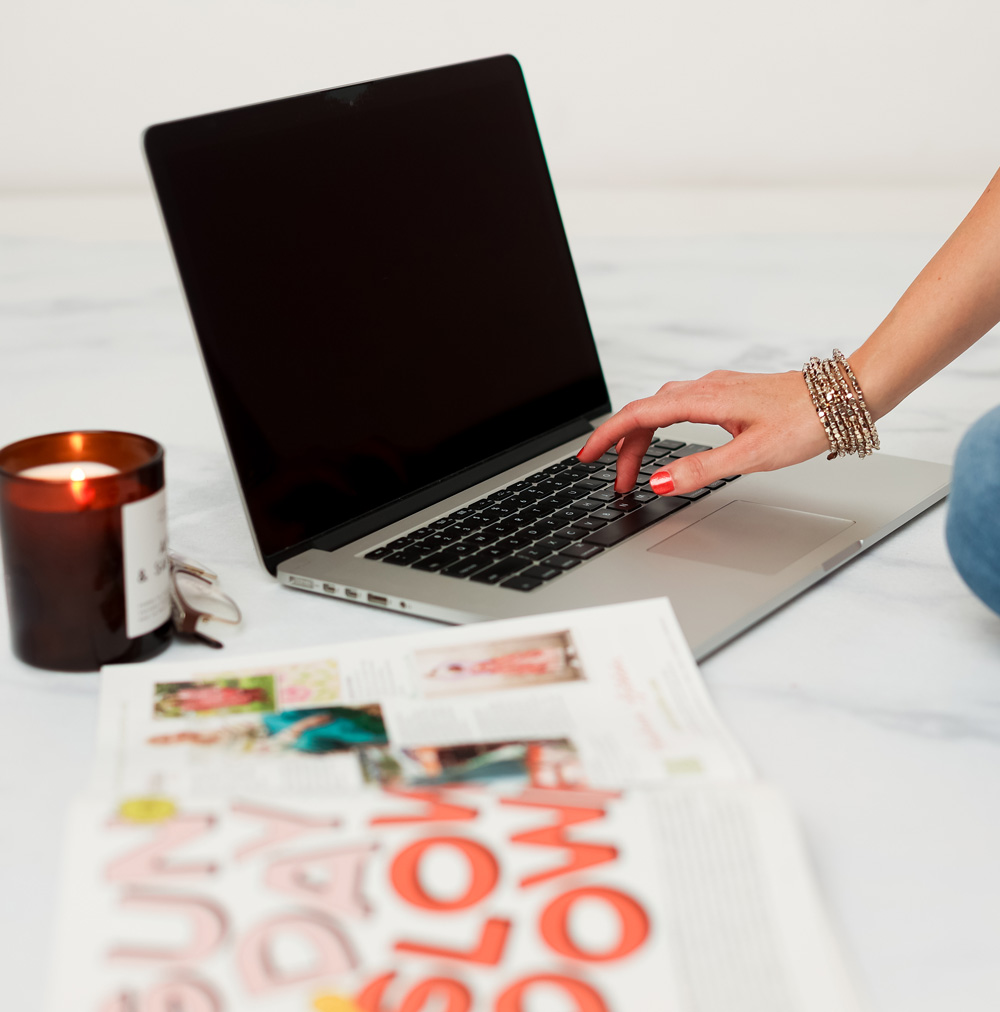 Sara motes using a computer to design a website
